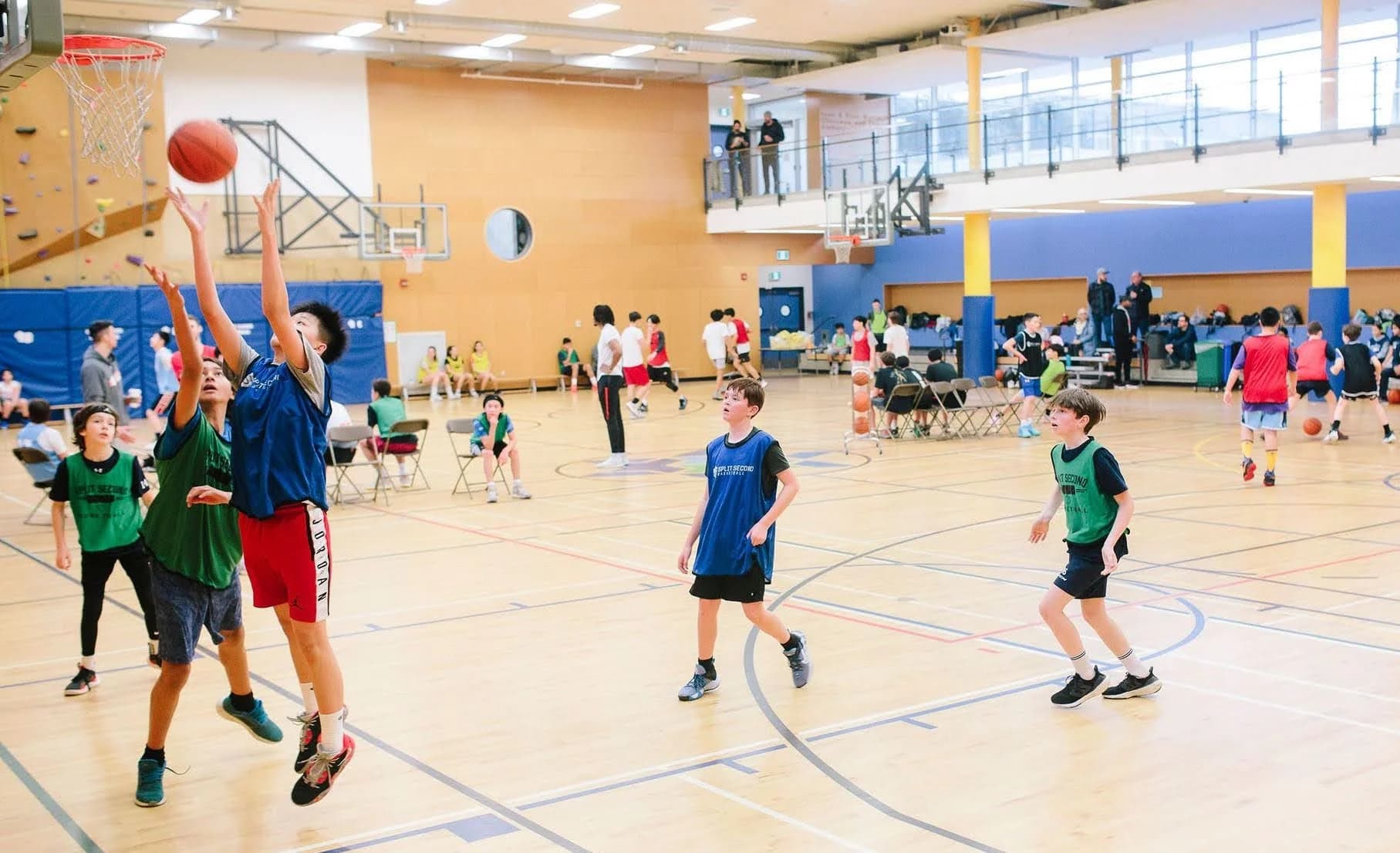 Kids playing 3x3 basketball together in an indoor gym