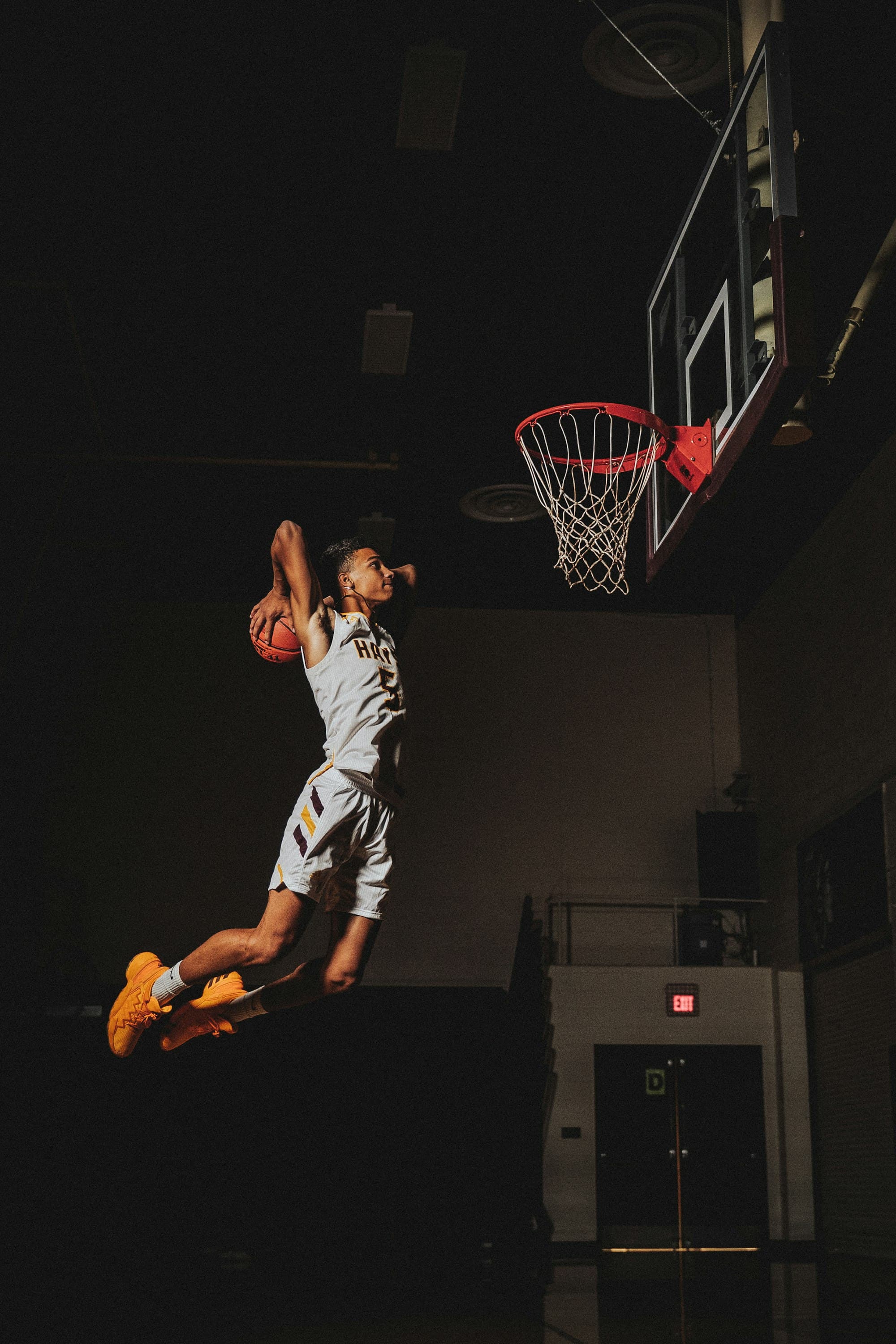 Young basketball player finishing a dramatic dunk in an intense 3x3 game